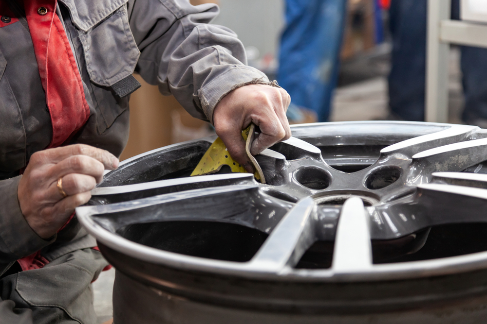 sanding an alloy wheel