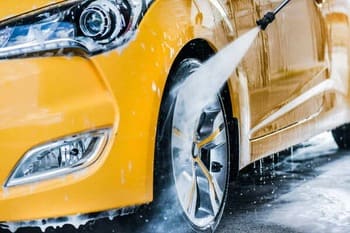 washing the car with wheel rim cleaner